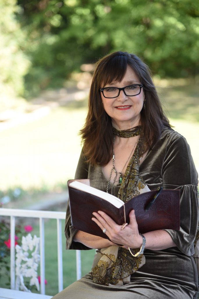 Chaplain Sue Davies-Rephan poses with her leather-bound vow book.