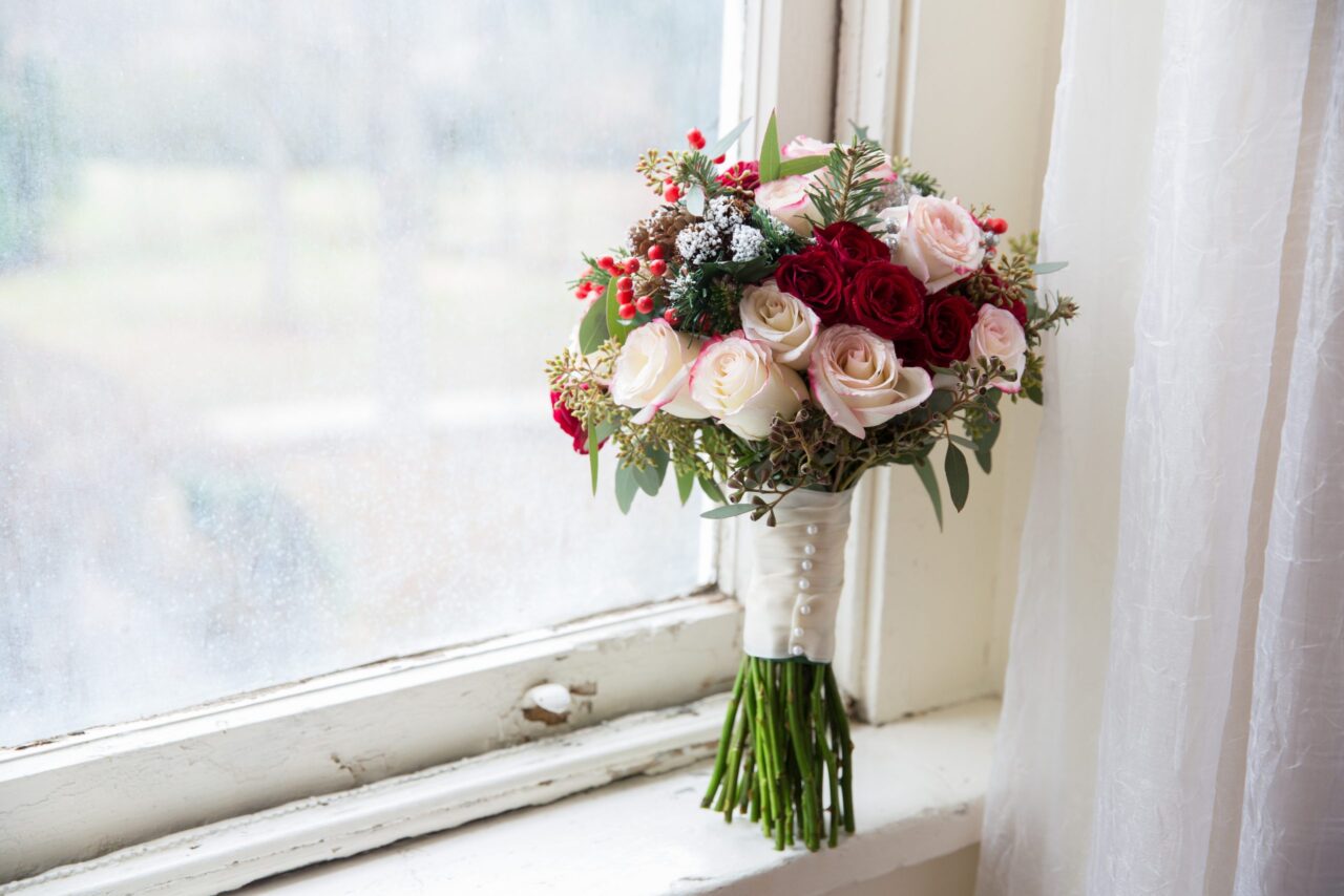 pink and red rose bouquet in window sill