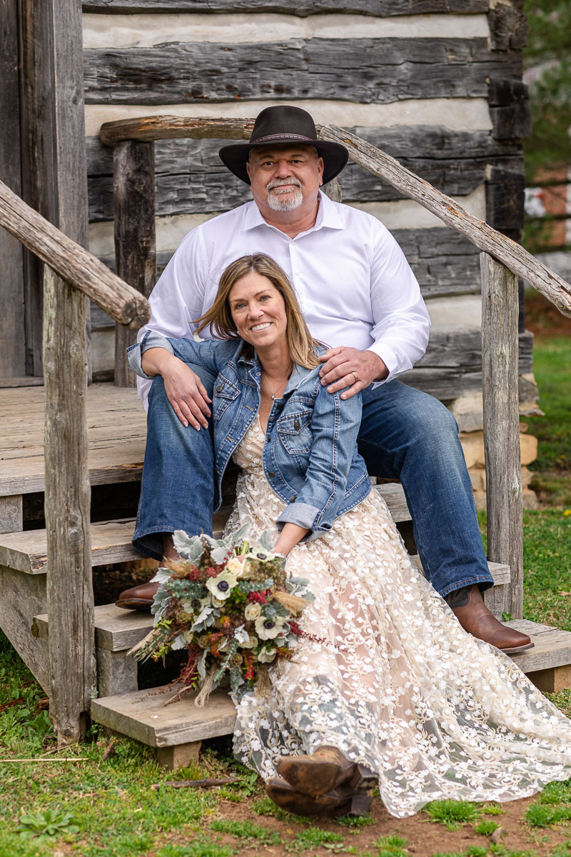 bride and groom on steps of rustic cabin