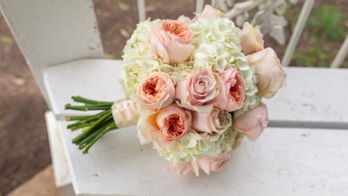 light pink roses and white flowers in a custom wedding bouquet with floral design by Elope in Nashville