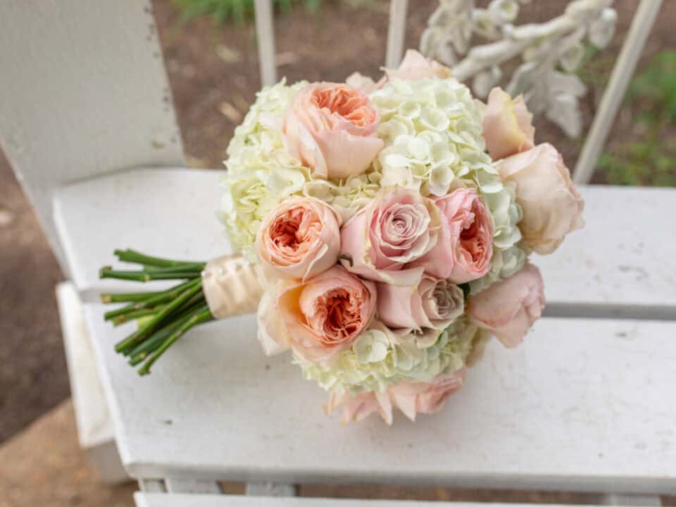light pink roses and white flowers in a custom wedding bouquet with floral design by Elope in Nashville